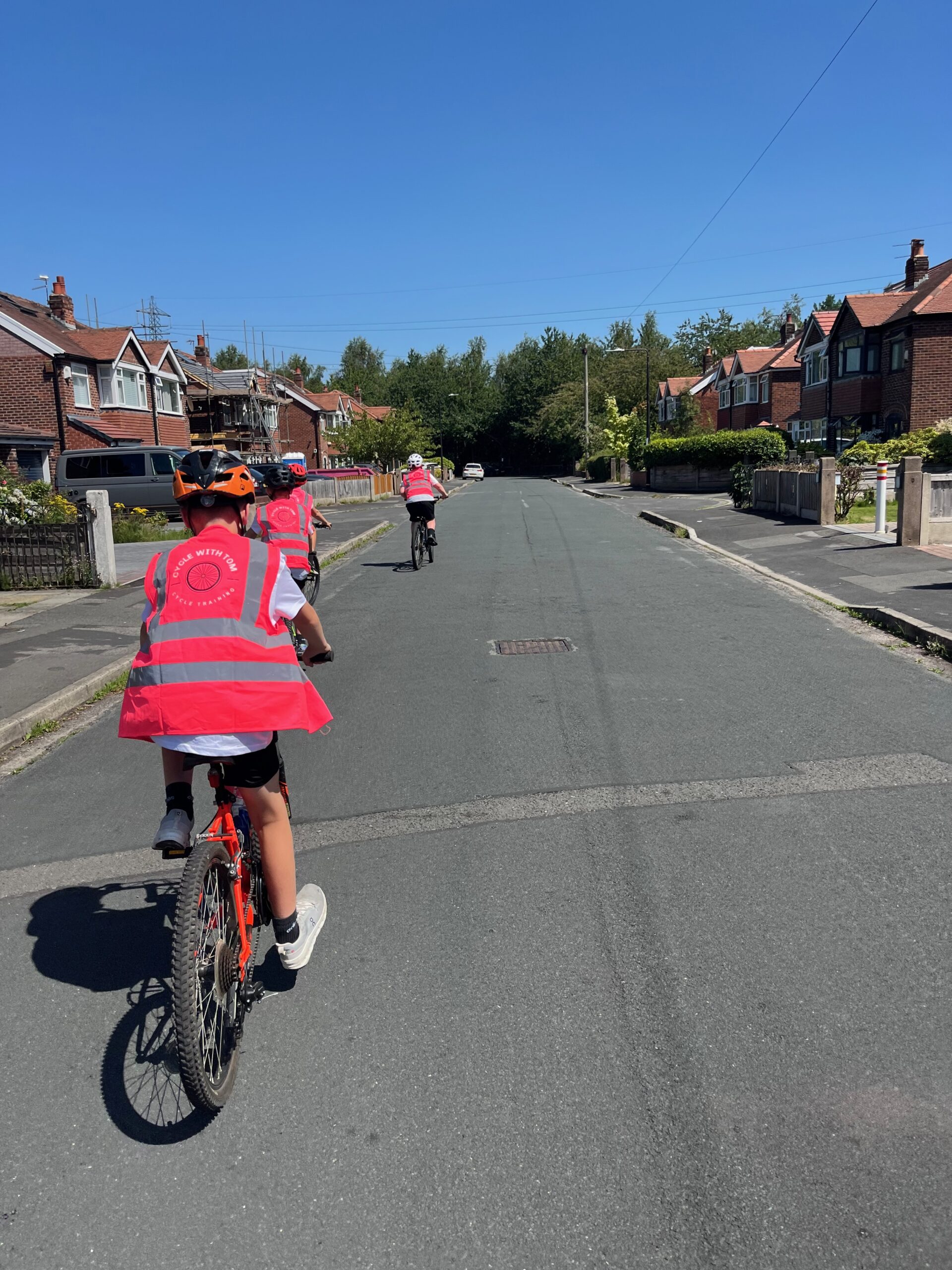 Four children cycling safely in the road