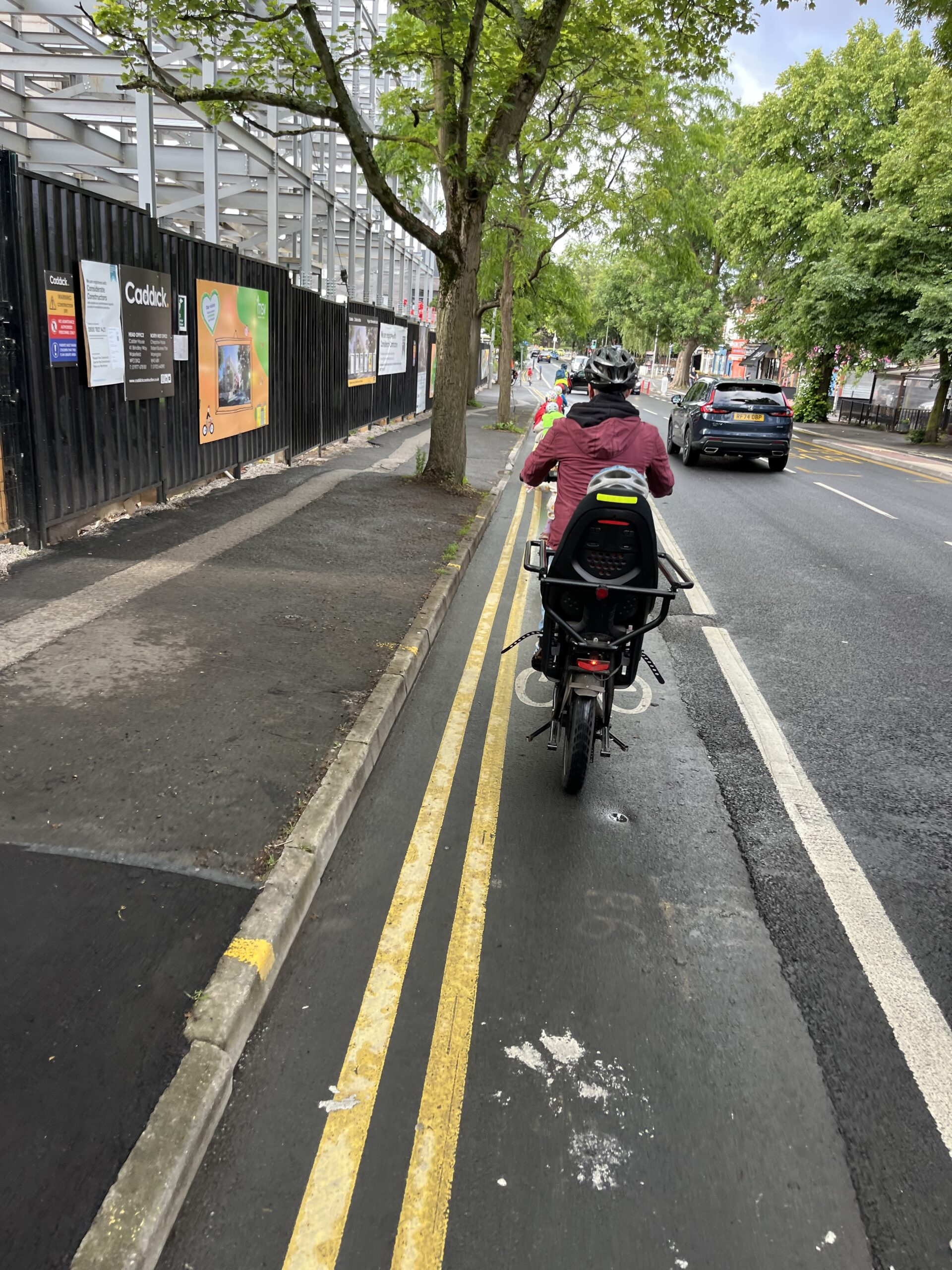 An Adult riding behind a group of children